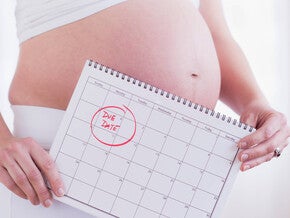 Pregnant Woman Holding a Calendar