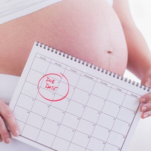 Pregnant Woman Holding a Calendar